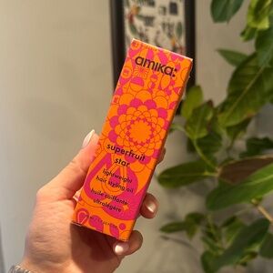 Amika Superfruit Star Hair Oil in Vibrant Orange and Pink